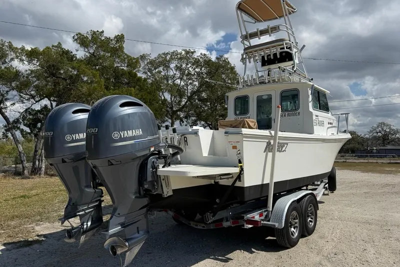 Slide: The Image of 2019 Parker 2520 XLD Sport Cabin boat with twin Yamaha 200 engines on a trailer. - 6