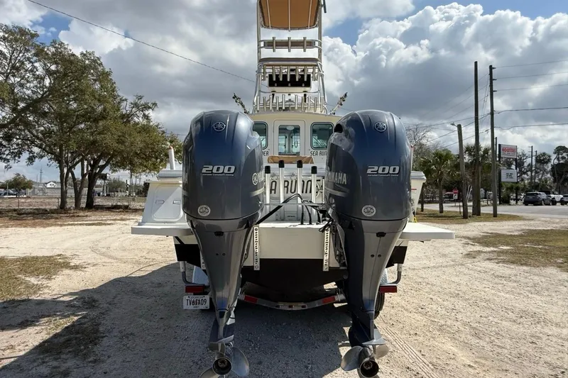 Slide: The Image of 2019 Parker 2520 XLD Sport Cabin boat with dual Yamaha 200 engines, parked outdoors. - 8