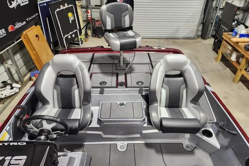 Slide: The Image of 2026 Nitro Z19 XL Pro boat interior with three gray and black seats in a garage setting. - 10