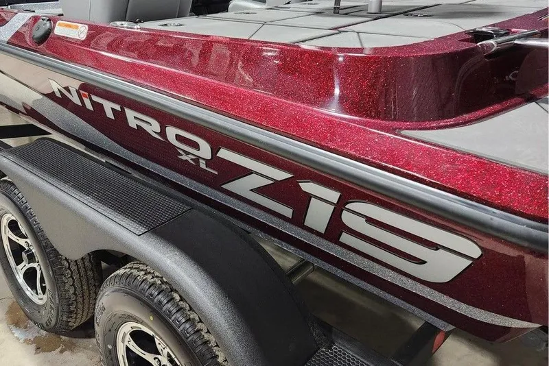 Slide: The Image of 2026 Nitro Z19 XL Pro boat with sparkling red finish on trailer. - 11