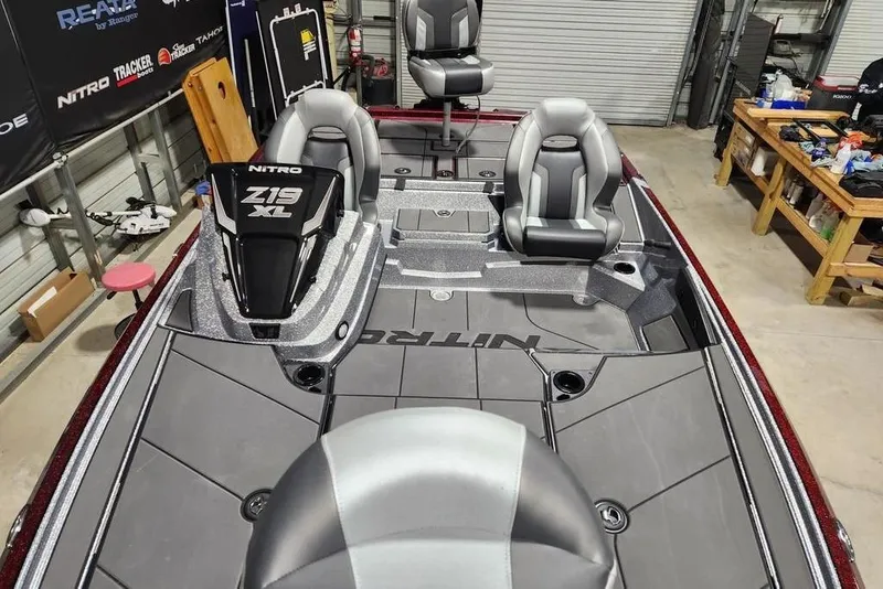 Slide: The Image of 2026 Nitro Z19 XL Pro boat interior with sleek seating and modern design in a workshop. - 12