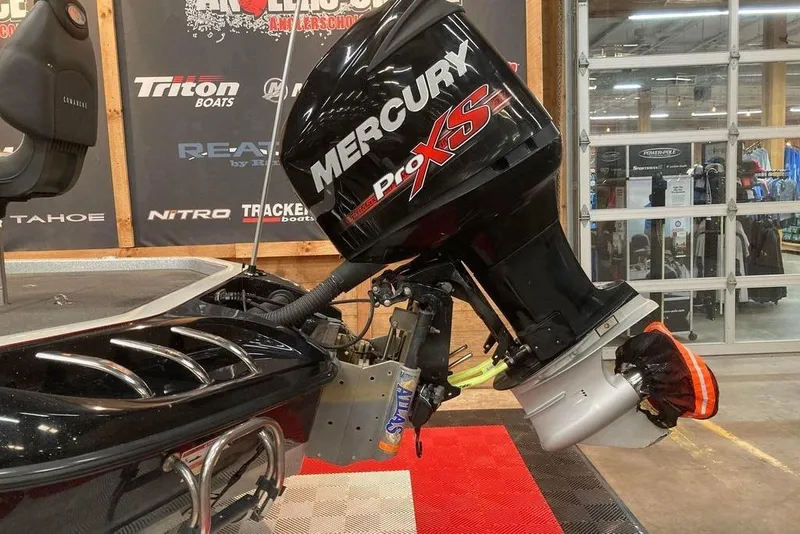 Slide: The Image of 2014 Ranger Z521 Comanche with Mercury Pro XS engine in showroom setting. - 4