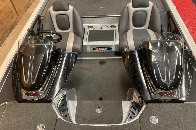 Slide: The Image of 2014 Ranger Z521 Comanche boat interior with dual seats and sleek black consoles. - 7