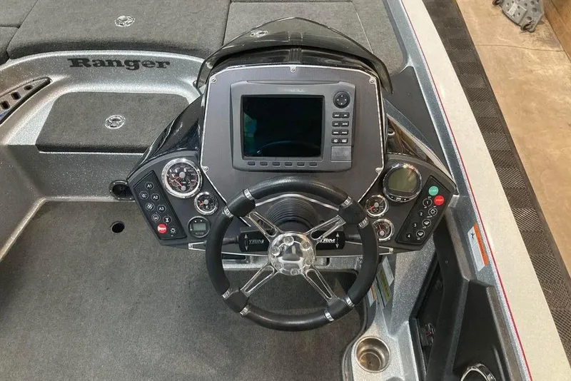 Slide: The Image of 2014 Ranger Z521 Comanche boat dashboard with steering wheel and electronic controls. - 8
