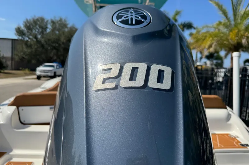 Slide: The Image of 2025 Key West 219 FS boat with Yamaha 200 engine, outdoor setting. - 13