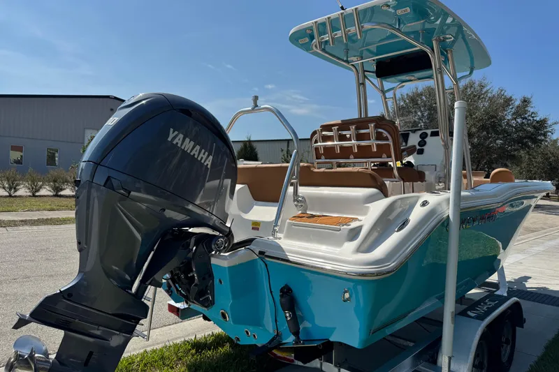 Slide: The Image of 2025 Key West 219 FS boat with Yamaha engine, parked on a trailer. - 14