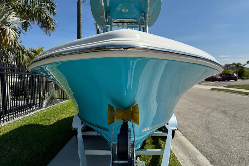 Slide: The Image of 2025 Key West 219 FS boat on trailer, vibrant blue hull, sunny day. - 17
