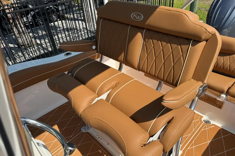 Slide: The Image of 2025 Key West 219 FS boat with luxurious brown leather seating and stylish design. - 23
