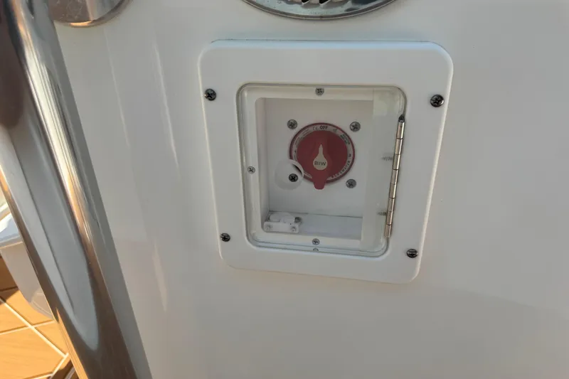 Slide: The Image of 2025 Key West 219 FS boat battery switch panel with protective cover. - 26