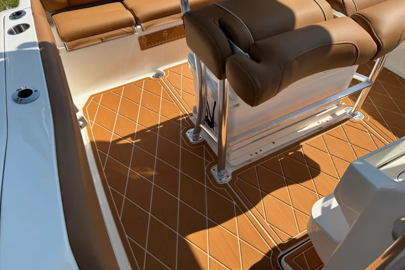 Slide: The Image of 2025 Key West 219 FS boat interior with tan seating and diamond-patterned flooring. - 27