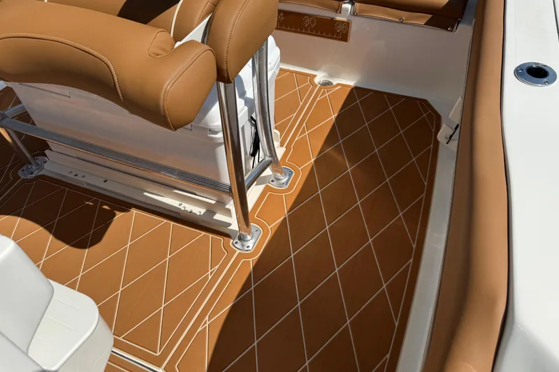 Slide: The Image of 2025 Key West 219 FS boat interior with tan cushioned seating and patterned flooring. - 28