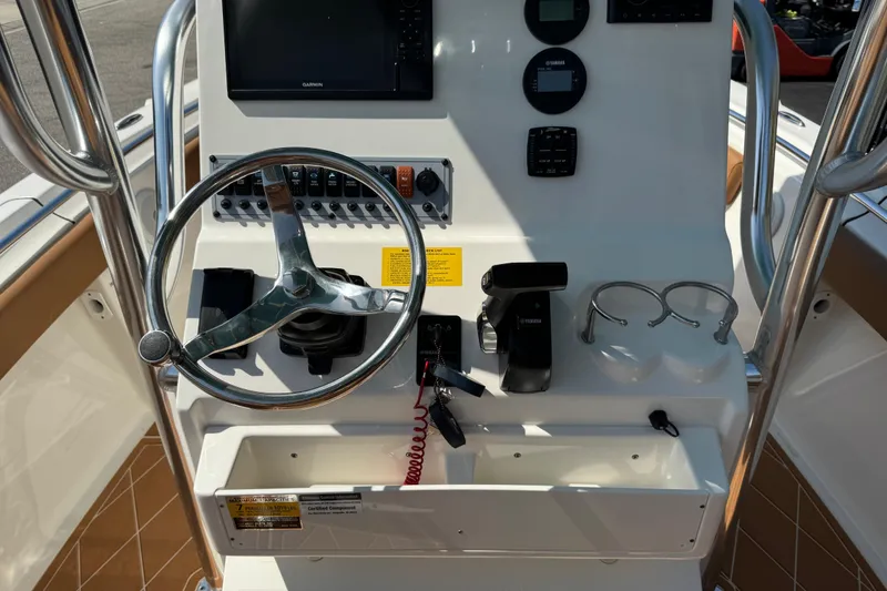 Slide: The Image of 2025 Key West 219 FS boat dashboard with steering wheel and controls. - 29