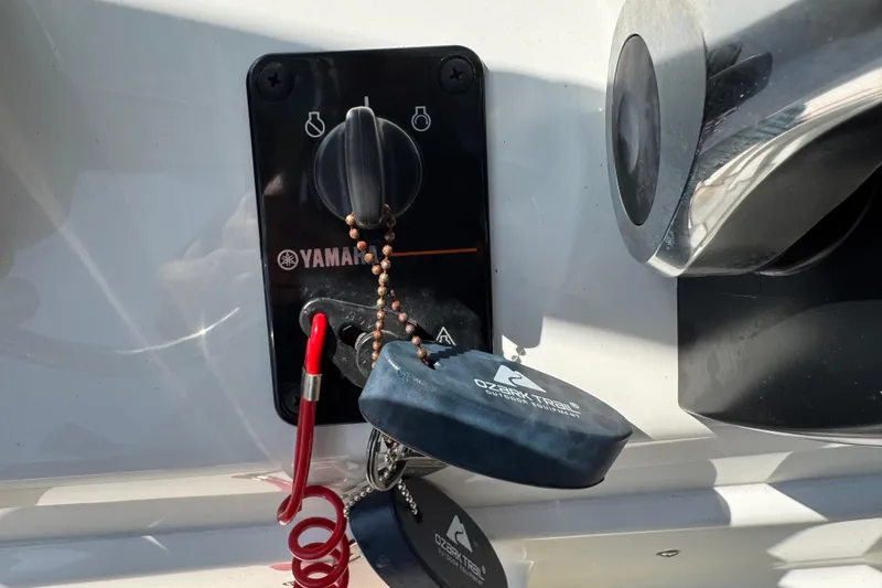 Slide: The Image of Yamaha ignition switch on 2025 Key West 219 FS boat with keys and safety lanyard. - 35