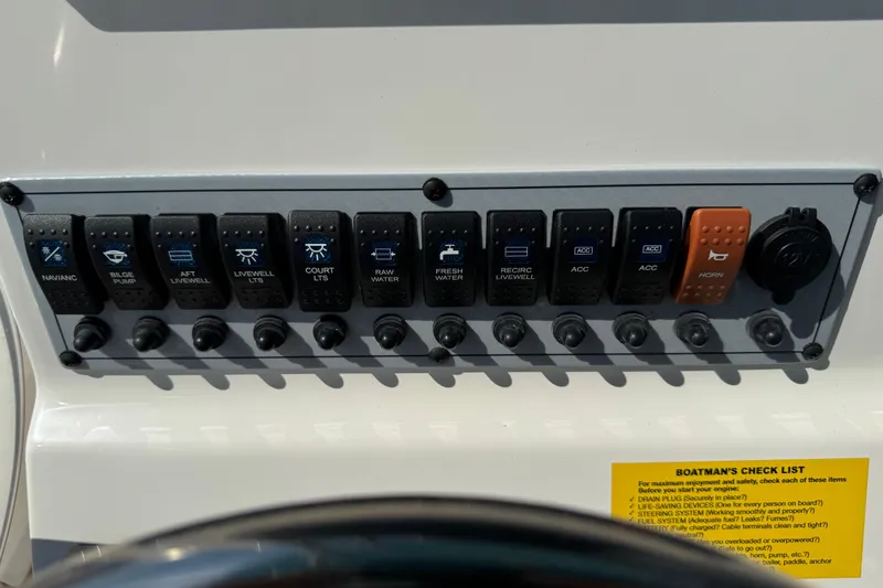 Slide: The Image of Control panel of 2025 Key West 219 FS boat with labeled switches and checklist. - 36
