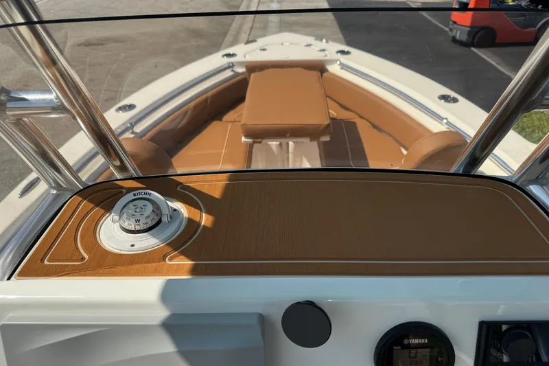 Slide: The Image of 2025 Key West 219 FS boat interior with compass and tan seating. - 44