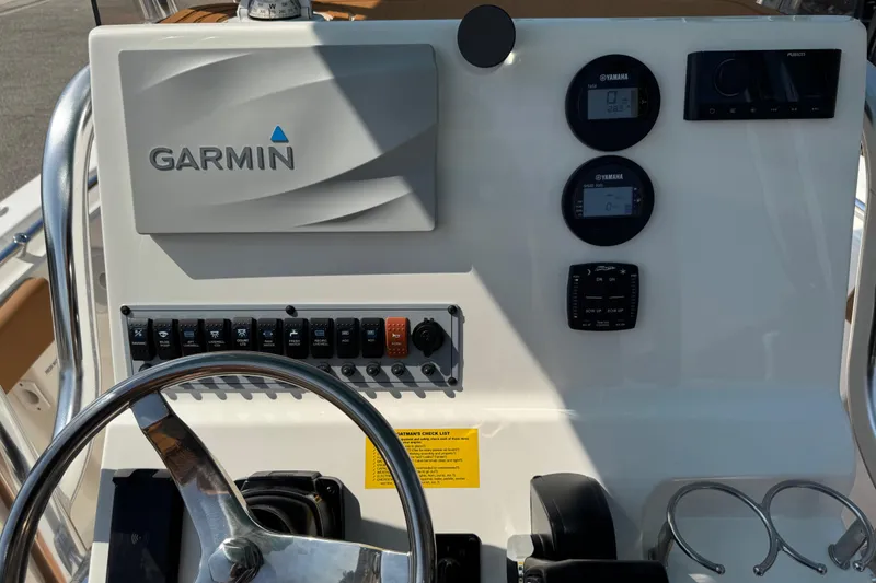 Slide: The Image of 2025 Key West 219 FS boat dashboard with Garmin navigation and Yamaha controls. - 46