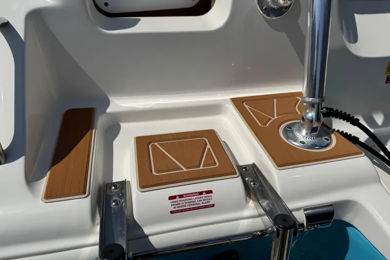 Slide: The Image of 2025 Key West 219 FS boat deck with teak accents and stainless steel fittings. - 5
