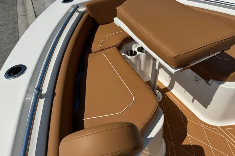 Slide: The Image of 2025 Key West 219 FS boat interior with tan cushioned seating and cup holders. - 53