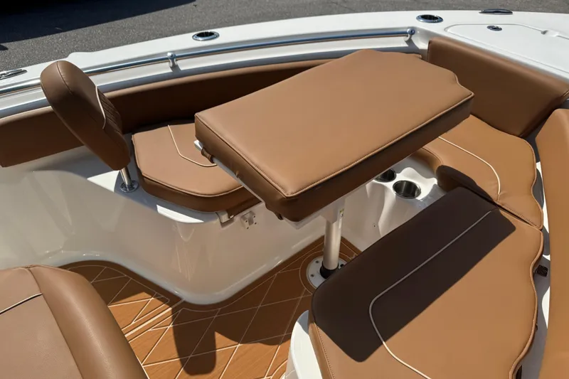 Slide: The Image of 2025 Key West 219 FS boat interior with brown cushioned seating and table. - 54