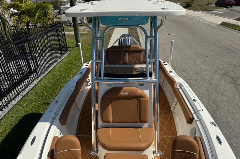 Slide: The Image of 2025 Key West 219 FS boat with tan seating and sleek design. - 56