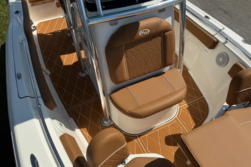 Slide: The Image of 2025 Key West 219 FS boat interior with brown cushioned seating and stylish flooring. - 58