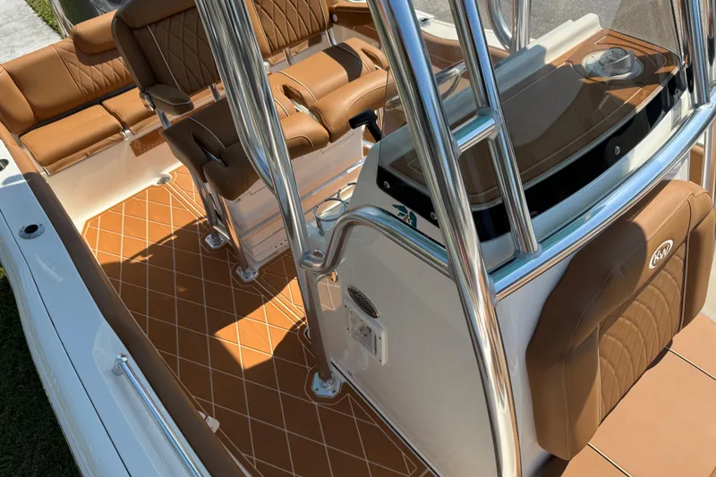 Slide: The Image of 2025 Key West 219 FS boat interior with brown seating and sleek design. - 59