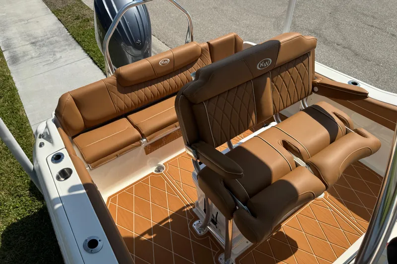 Slide: The Image of 2025 Key West 219 FS boat interior with tan leather seating and diamond-pattern flooring. - 60