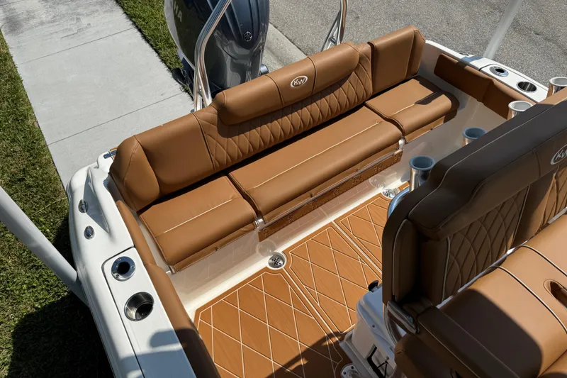 Slide: The Image of 2025 Key West 219 FS boat interior with tan leather seating and diamond-pattern flooring. - 61
