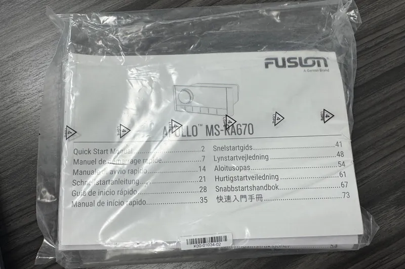 Slide: The Image of Instruction manual for Fusion MS-RA70, packaged in plastic, on a wooden surface. - 78