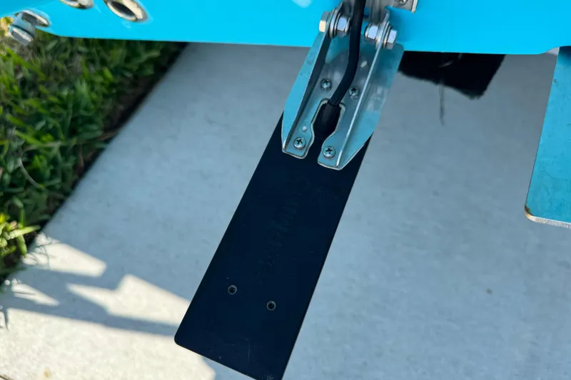 Slide: The Image of 2025 Key West 219 FS boat detail showing trim tab mechanism. - 8