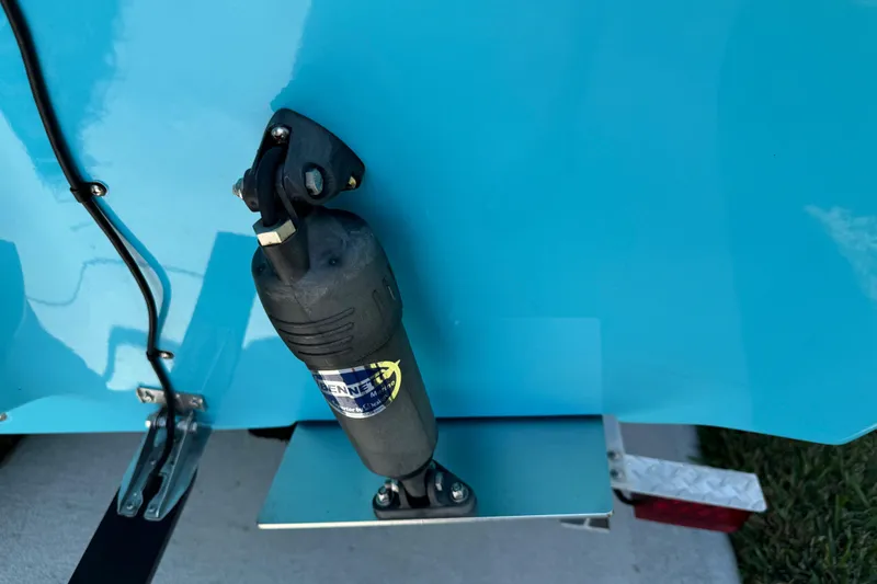 Slide: The Image of Trim tab actuator on 2025 Key West 219 FS boat, blue hull detail. - 9