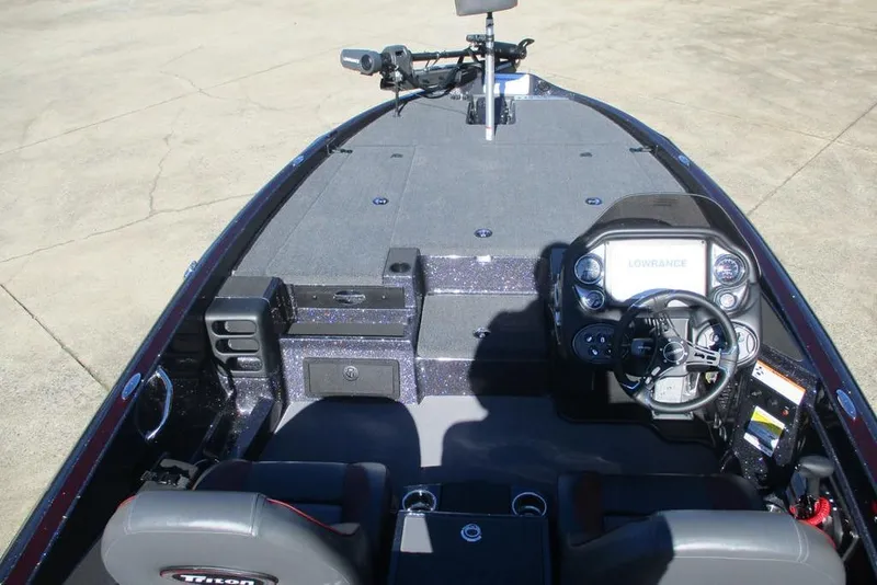 Slide: The Image of 2025 Triton 19 TrX Patriot boat interior with advanced navigation system and spacious seating. - 6
