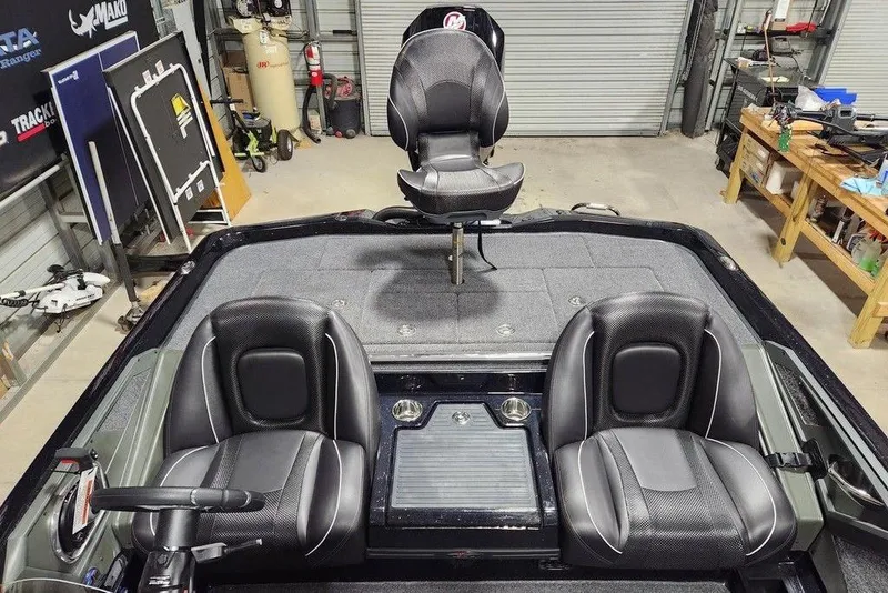 Slide: The Image of 2014 Ranger Z518 Cup-Equipped boat interior with three black seats in a garage setting. - 12