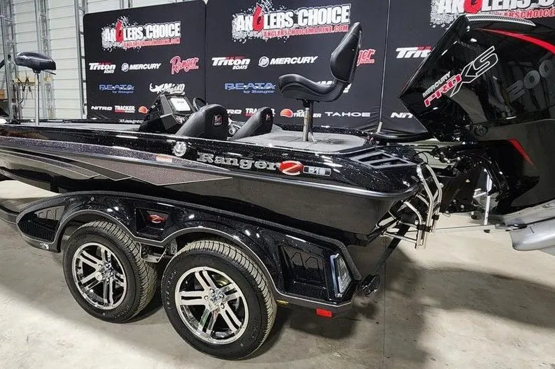 Slide: The Image of 2014 Ranger Z518 Cup-Equipped boat on display with dual axle trailer. - 2