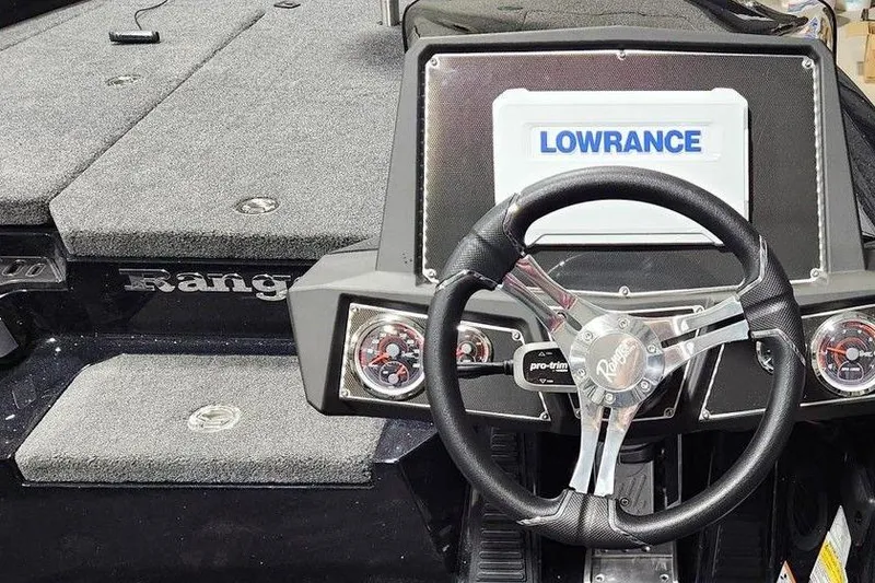 Slide: The Image of 2014 Ranger Z518 Cup-Equipped boat dashboard with Lowrance display and steering wheel. - 3
