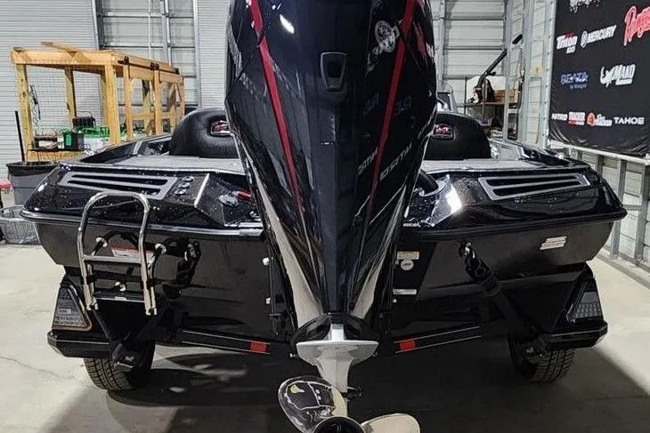 Slide: The Image of 2014 Ranger Z518 Cup-Equipped boat in a garage, showcasing its powerful engine and sleek design. - 4