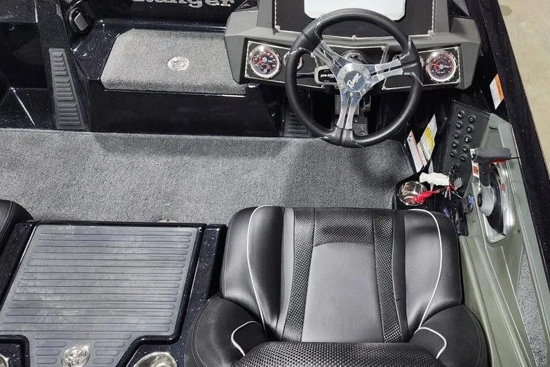 Slide: The Image of 2014 Ranger Z518 Cup-Equipped boat interior with steering wheel and seating. - 6