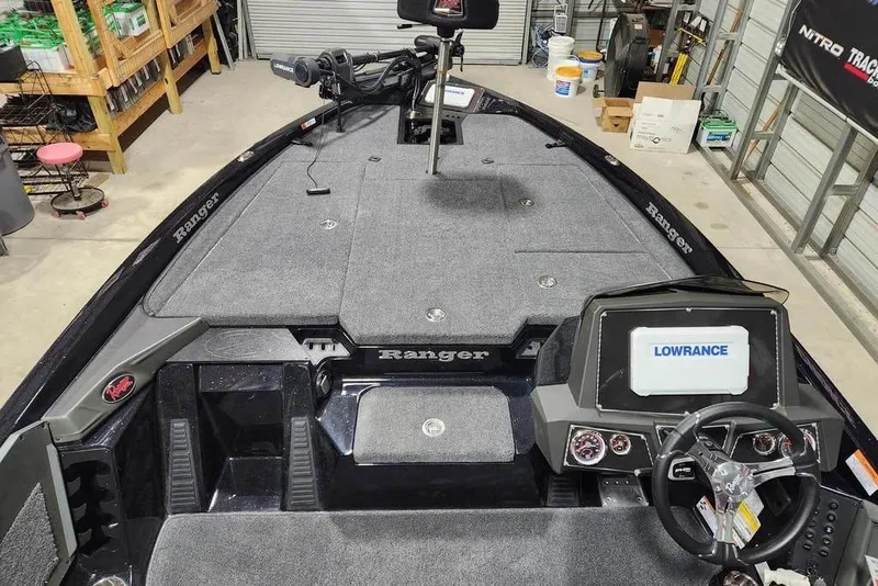 Slide: The Image of 2014 Ranger Z518 Cup-Equipped boat interior with Lowrance electronics in a garage setting. - 9