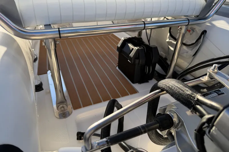 Slide: The Image of Interior of a 2014 Caribe C10X boat with seating and equipment. - 15
