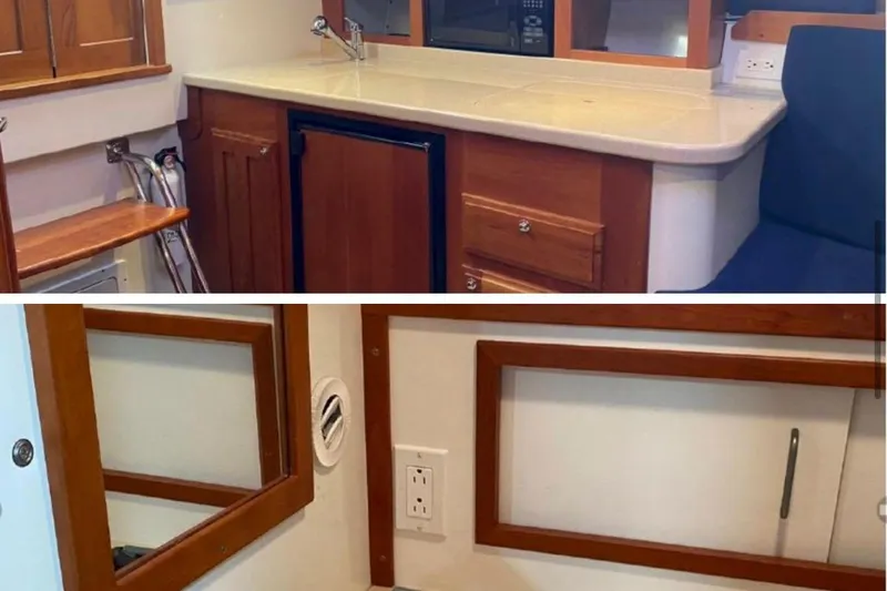 Slide: The Image of 2006 Back Cove 29 interior with wooden cabinetry, compact kitchen, and seating area. - 4