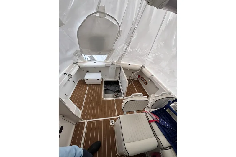 Slide: The Image of 2006 Back Cove 29 boat interior with wood flooring and white seating. - 7