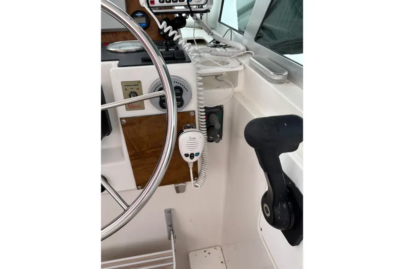 Slide: The Image of 2006 Back Cove 29 boat helm with steering wheel and control panel. - 8