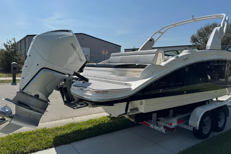 Slide: The Image of 2019 Sea Ray SDX 270 Outboard boat on trailer, featuring a powerful Mercury engine. - 10