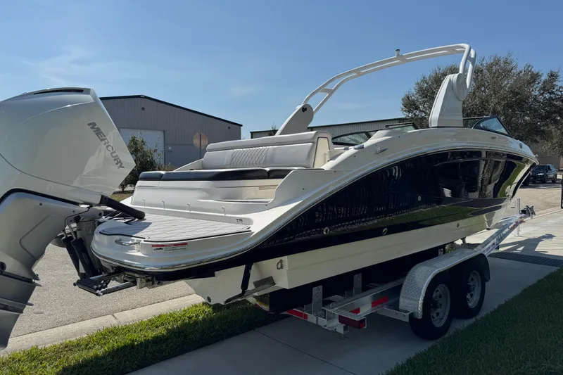 Slide: The Image of 2019 Sea Ray SDX 270 Outboard boat on trailer, featuring a sleek design and Mercury engine. - 11