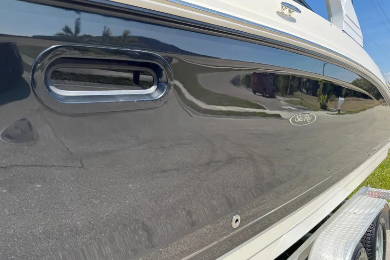 Slide: The Image of 2019 Sea Ray SDX 270 Outboard boat side view with sleek black finish. - 16