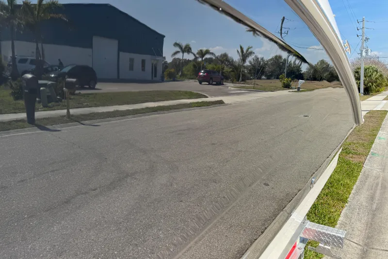 Slide: The Image of Reflection on 2019 Sea Ray SDX 270 Outboard hull, showing street and building. - 17