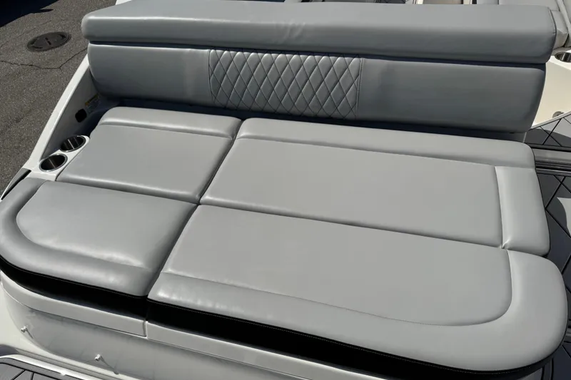 Slide: The Image of 2019 Sea Ray SDX 270 Outboard boat with gray cushioned seating and cup holders. - 19