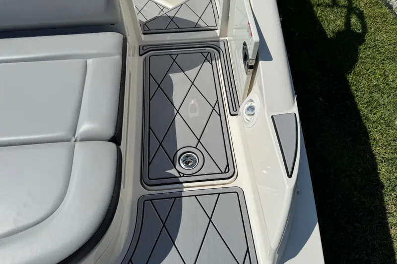 Slide: The Image of 2019 Sea Ray SDX 270 Outboard boat deck with cushioned seating and stylish flooring. - 20