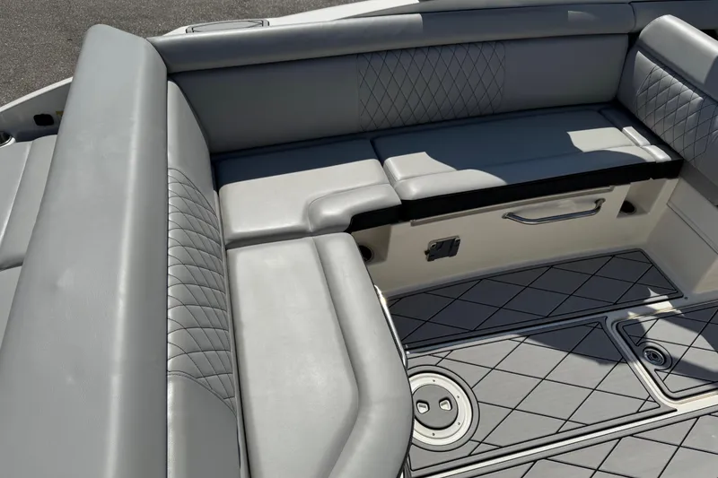 Slide: The Image of 2019 Sea Ray SDX 270 Outboard interior with gray seating and diamond-patterned flooring. - 22