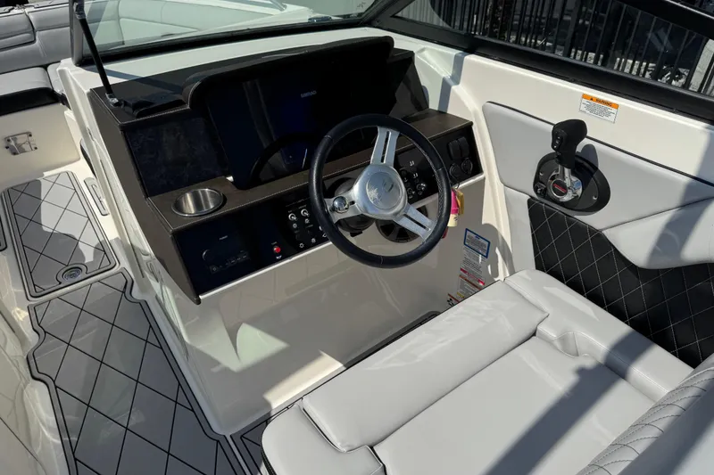 Slide: The Image of 2019 Sea Ray SDX 270 Outboard helm with modern controls and luxurious seating. - 25